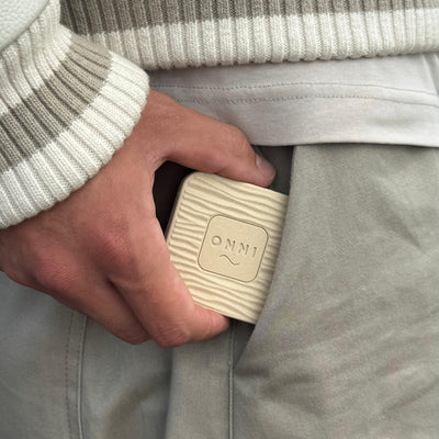 The Classic Birch Kiuas, wood-grain wave and ONNI mark, held at the pocket