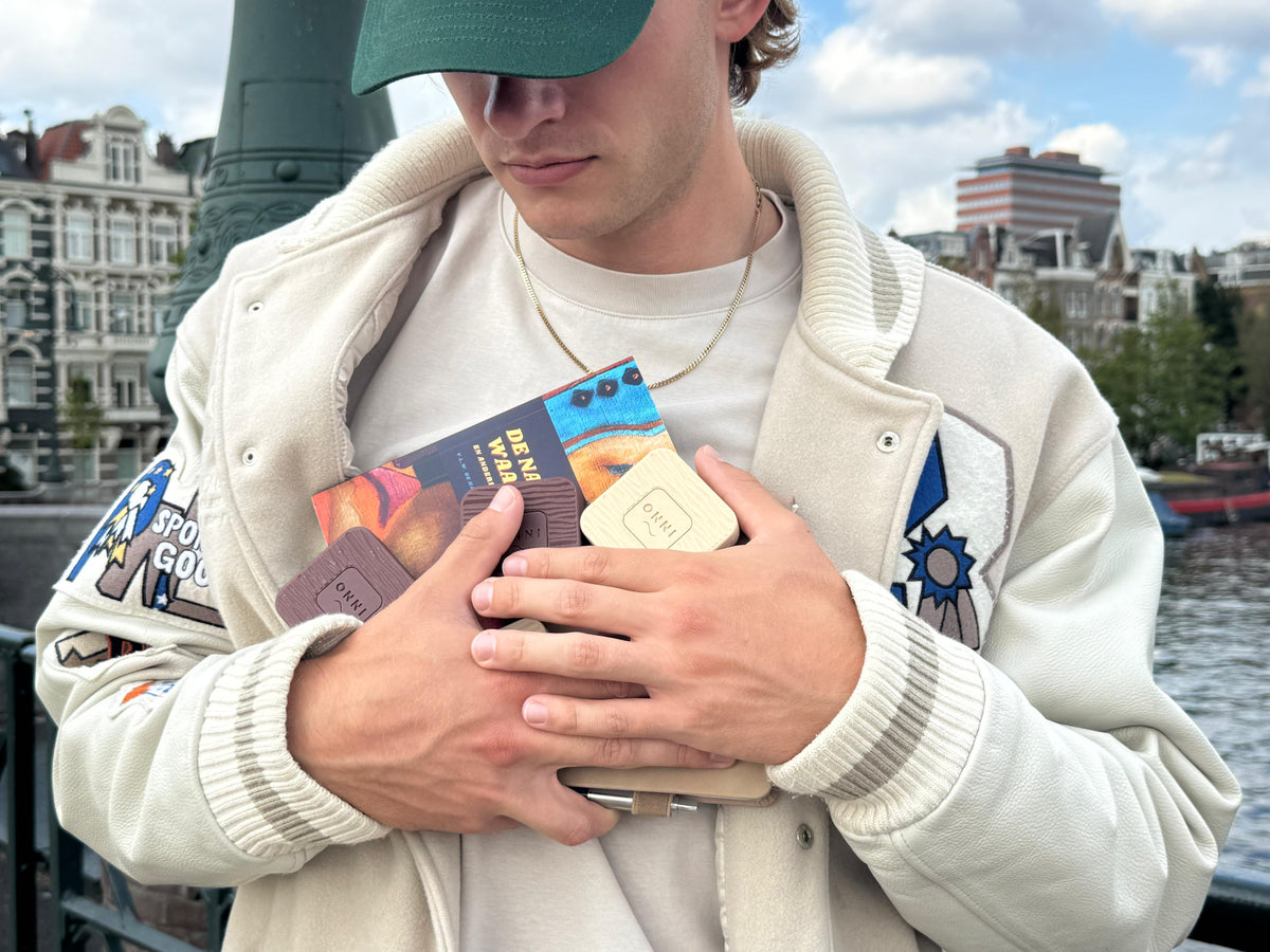 Holding the day's analogue essentials by the canal