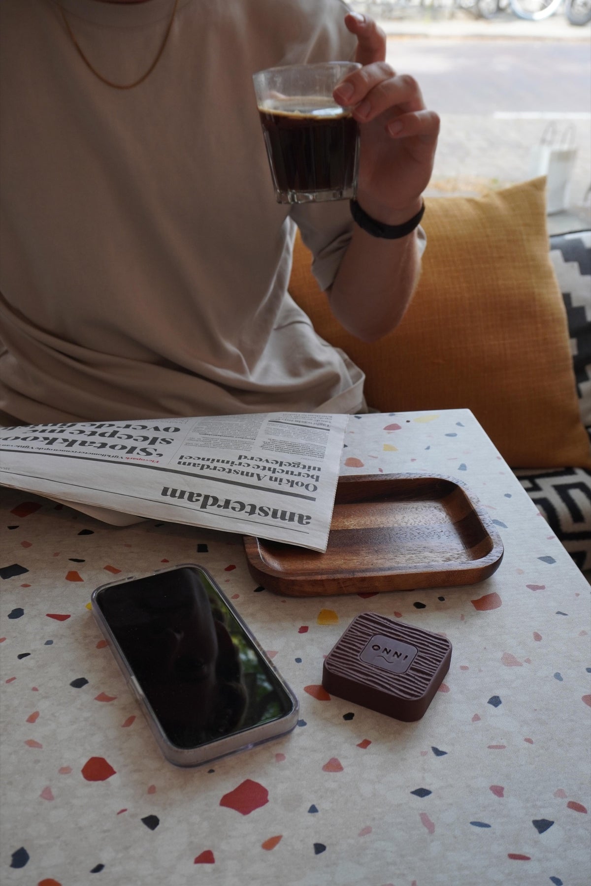 Coffee and a newspaper, with the phone put aside beside a Walnut Kiuas