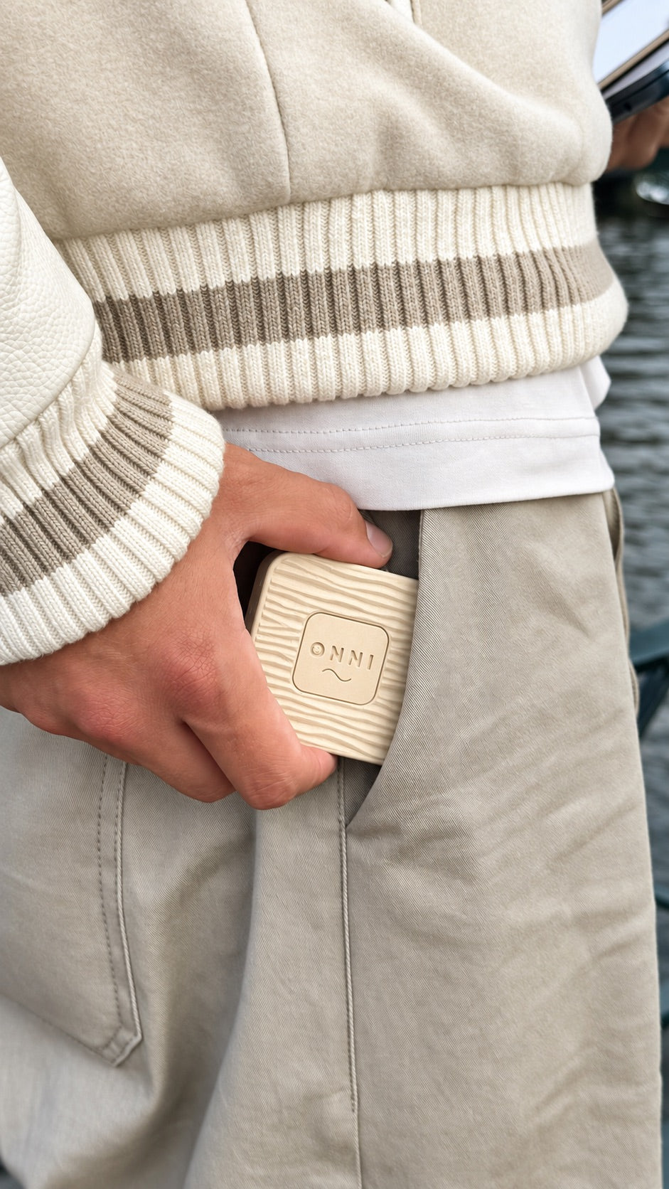 The Classic Birch Kiuas, wood-grain wave and ONNI mark, held at the pocket